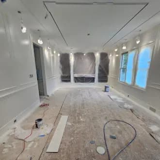 Dining room before — stripped to the studs with protective plastic sheeting